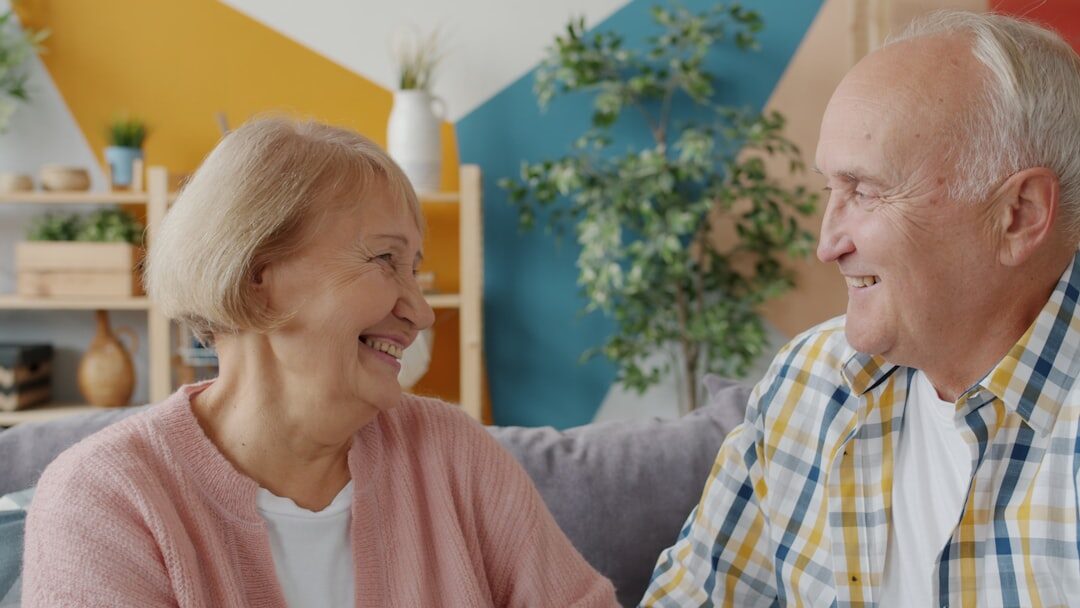 Elderly couple reviewing legal paperwork together at home