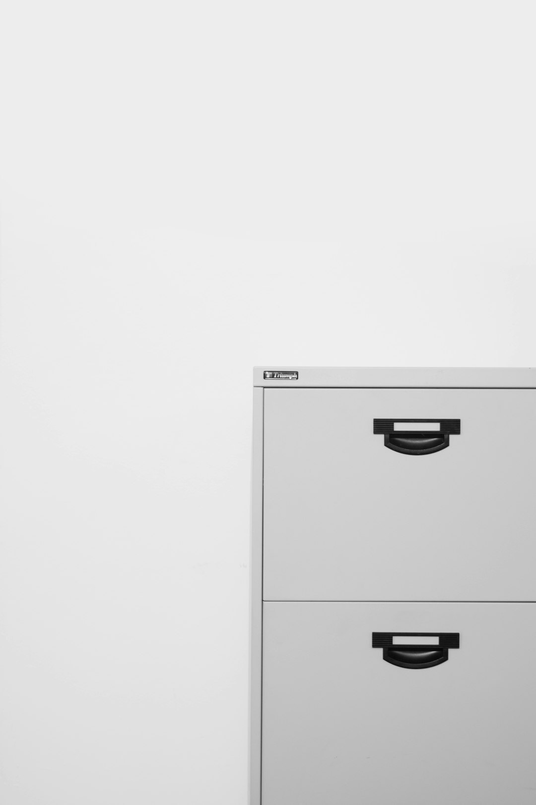 Person organizing legal document folders in an office filing cabinet